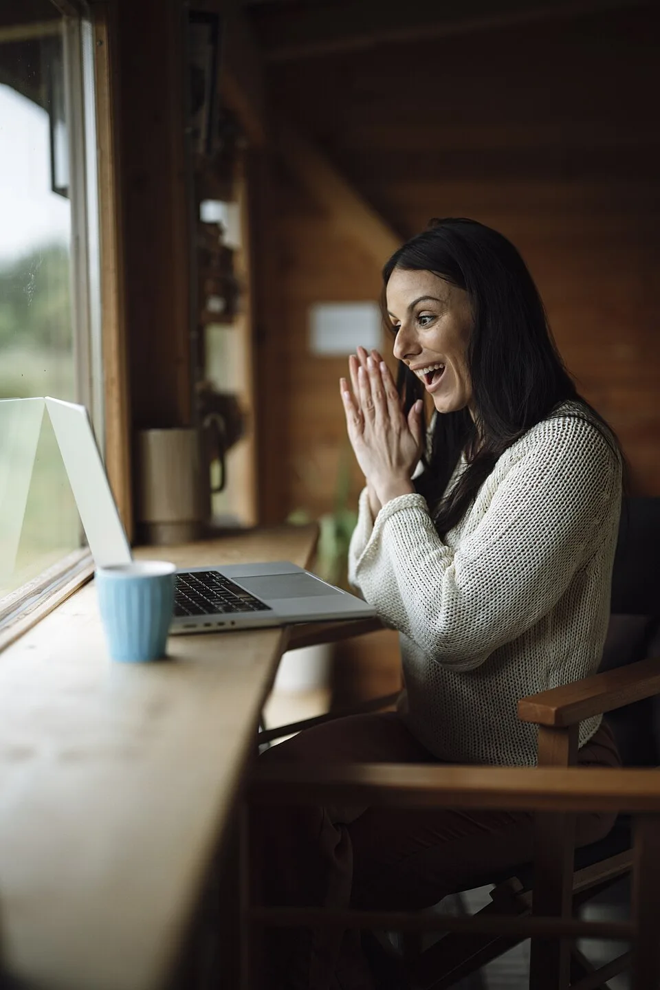 An adult woman reacting during a laptop video call